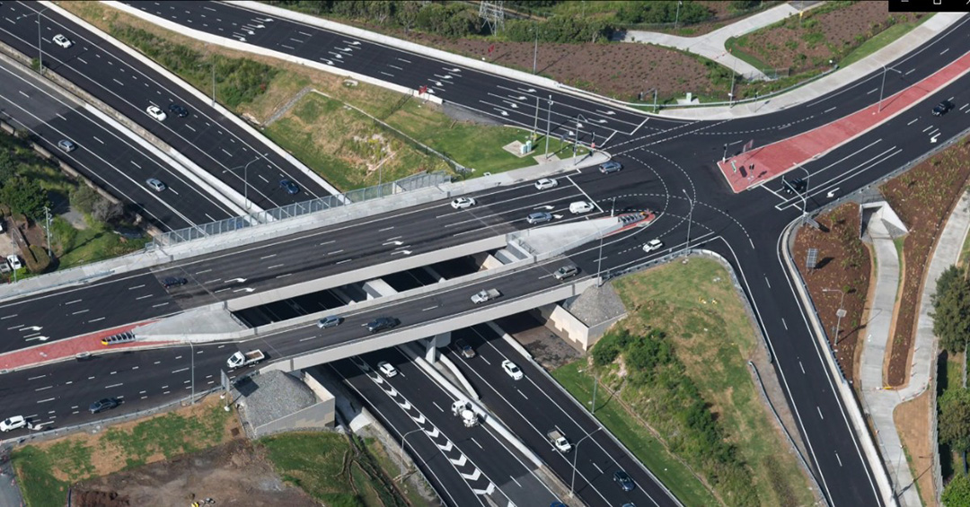 Aerial view of Sumners Road interchange looking south - including the shared path on the westbound bridge and grade-separated cycle track and tunnel under the western intersection of the overpass.
